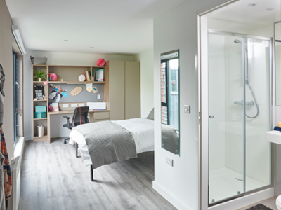 The bedroom features a double bed, large window and ensuite shower