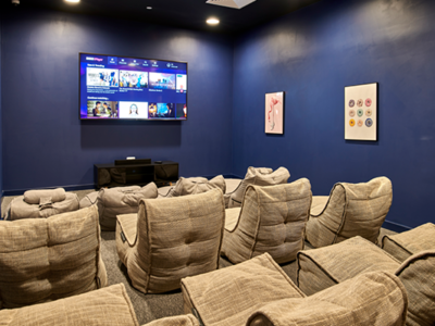 The on-site cinema features a large screen and comfy chairs