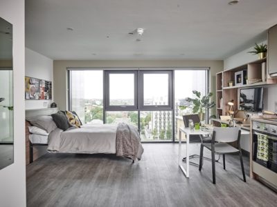 The resident bedroom features large windows for lots of natural light